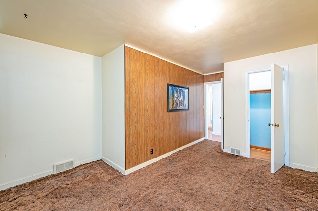 1202 Webster St, Fairmont, MN 56031 - carpeted empty room with baseboards and wood walls