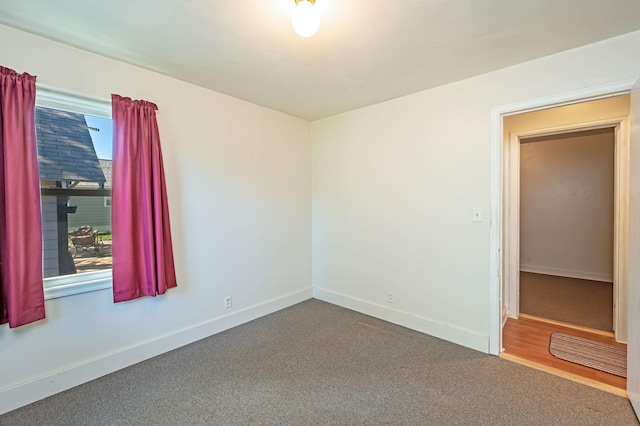 1202 Webster St, Fairmont, MN 56031 - spare room featuring baseboards and dark carpet