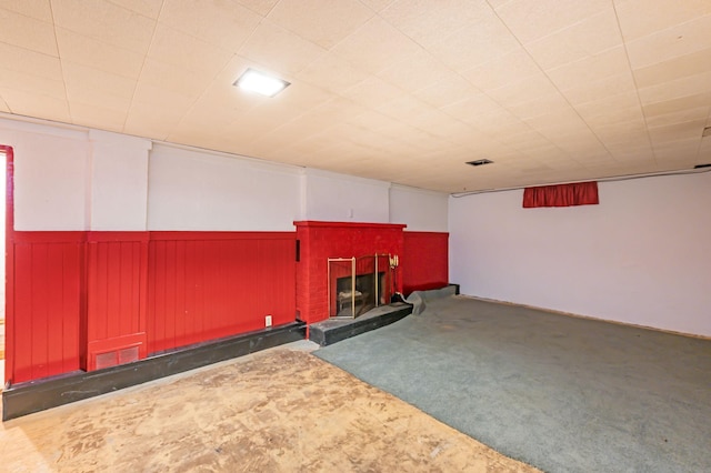 1202 Webster St, Fairmont, MN 56031 - finished below grade area featuring a brick fireplace, carpet, and wainscoting