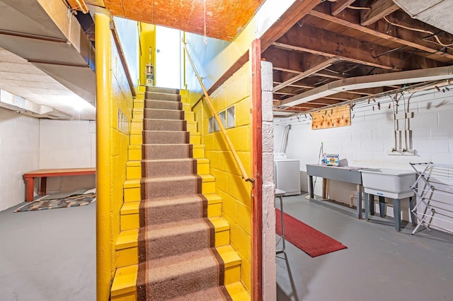 1202 Webster St, Fairmont, MN 56031 - stairs featuring concrete flooring, washer / dryer, and concrete block wall