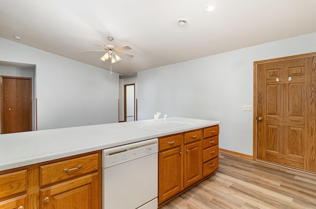 202 6th St NE, Montgomery, MN 56069 - kitchen featuring dishwasher, a sink, a ceiling fan, light wood-type flooring, and light countertops