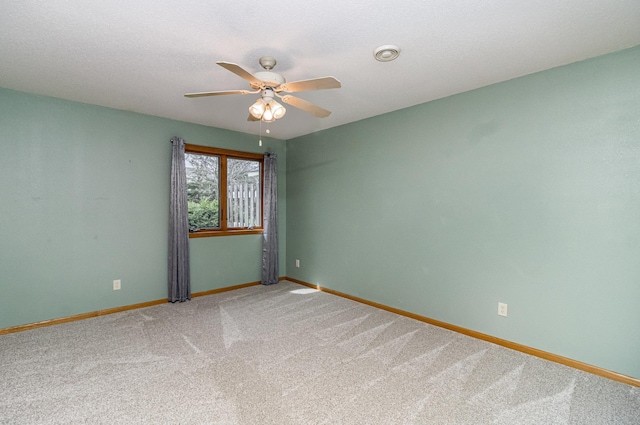 202 6th St NE, Montgomery, MN 56069 - carpeted empty room featuring a ceiling fan and baseboards