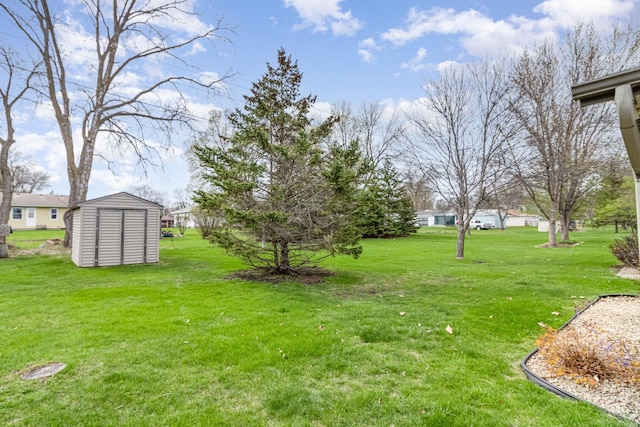 202 6th St NE, Montgomery, MN 56069 - view of green lawn featuring a storage unit and an outdoor structure
