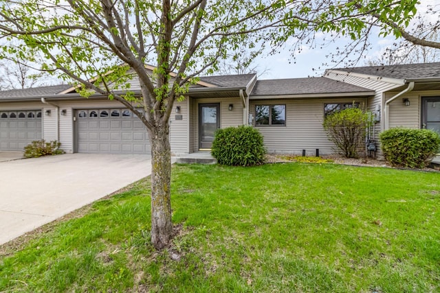 202 6th St NE, Montgomery, MN 56069 - ranch-style home with driveway, a front lawn, a garage, and a shingled roof