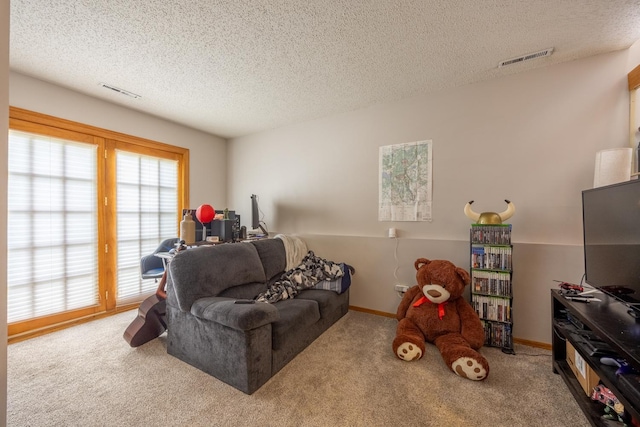 carpeted living room featuring a textured ceiling and baseboards