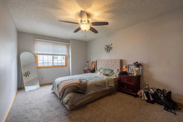 bedroom with carpet, a textured ceiling, ceiling fan, and baseboards