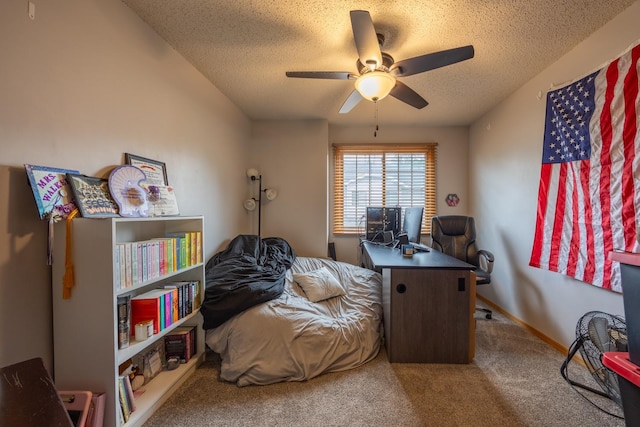 bedroom with carpet, a textured ceiling, a desk, and ceiling fan