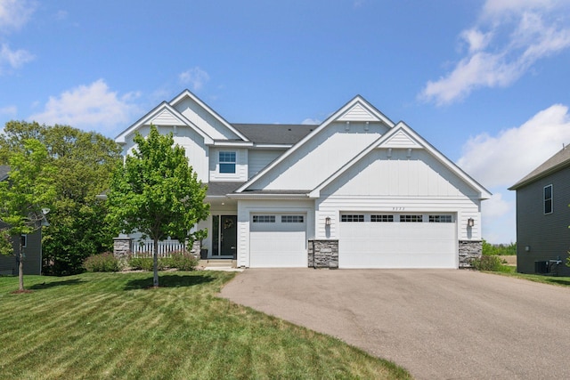 9222 Bridle Way, Victoria, MN 55386 - craftsman-style house with driveway, stone siding, a front lawn, central air condition unit, and a garage