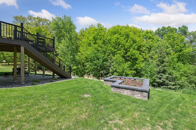 9222 Bridle Way, Victoria, MN 55386 - view of grassy yard with stairs, a garden, and a wooden deck
