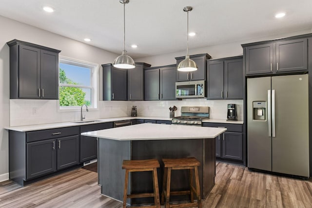9222 Bridle Way, Victoria, MN 55386 - kitchen featuring stainless steel appliances, a sink, decorative backsplash, wood finished floors, and recessed lighting