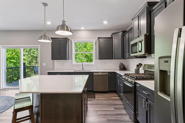 9222 Bridle Way, Victoria, MN 55386 - kitchen with appliances with stainless steel finishes, a sink, a center island, tasteful backsplash, and recessed lighting