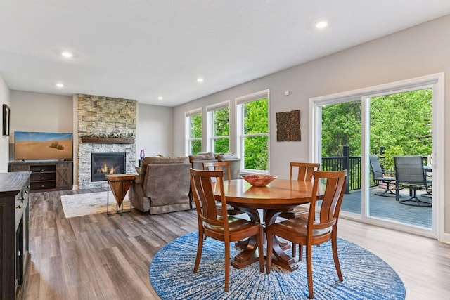 9222 Bridle Way, Victoria, MN 55386 - dining space featuring wood finished floors, a fireplace, and recessed lighting