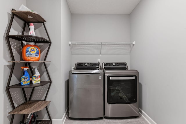 9222 Bridle Way, Victoria, MN 55386 - clothes washing area with baseboards and washer and clothes dryer