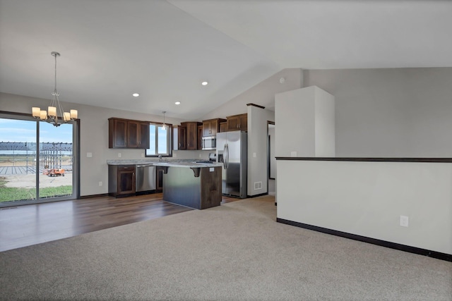 1311 Jasmine Ln NE, Saint Joseph, MN 56374 - kitchen with appliances with stainless steel finishes, a chandelier, a center island, open floor plan, and dark carpet