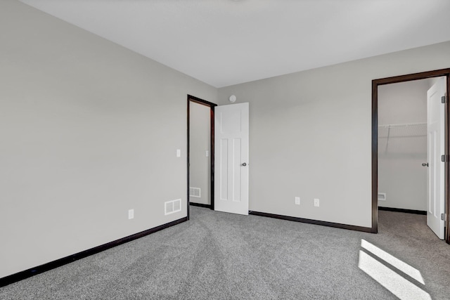 1311 Jasmine Ln NE, Saint Joseph, MN 56374 - unfurnished bedroom featuring carpet, baseboards, a spacious closet, and a closet