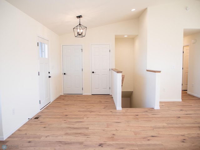 10302 Burgundy Dr, Horace, ND 58047 - entryway featuring light wood-style flooring, vaulted ceiling, baseboards, and recessed lighting