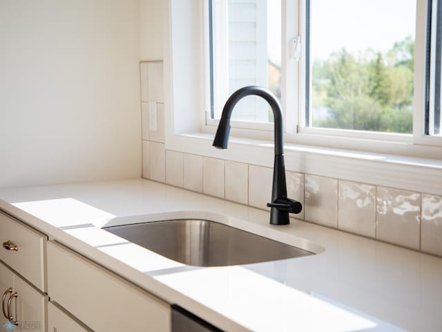 10302 Burgundy Dr, Horace, ND 58047 - kitchen view of a sink, light countertops, and decorative backsplash