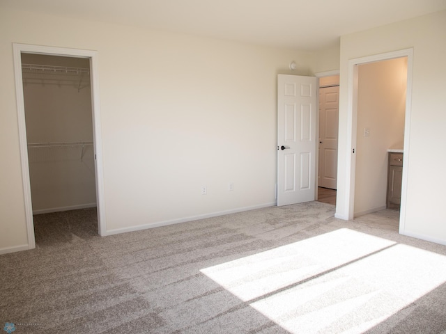 10302 Burgundy Dr, Horace, ND 58047 - unfurnished bedroom featuring a walk in closet, carpet flooring, and baseboards