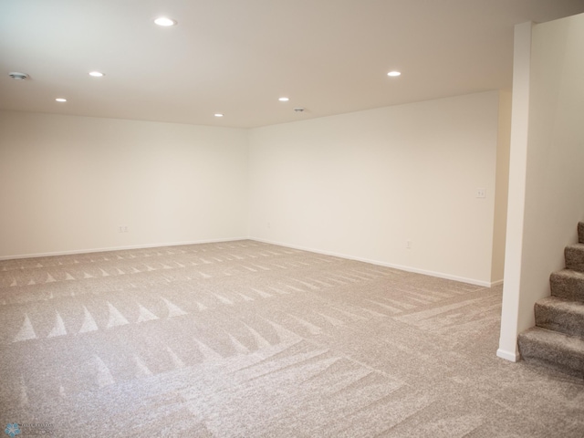 10302 Burgundy Dr, Horace, ND 58047 - below grade area with light carpet, recessed lighting, stairway, and baseboards