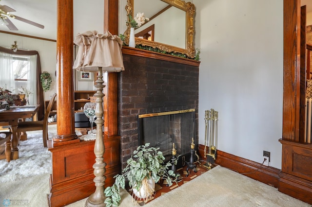 carpeted living room with a ceiling fan, a brick fireplace, and ornamental molding