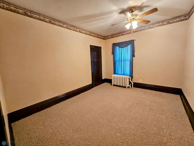 carpeted empty room featuring radiator, a ceiling fan, and baseboards