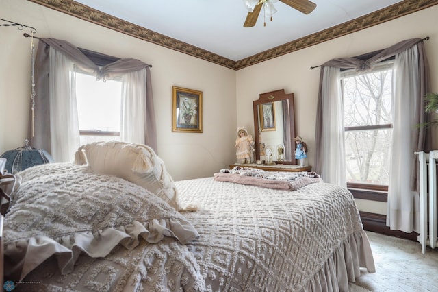 bedroom with multiple windows, light carpet, a ceiling fan, and crown molding