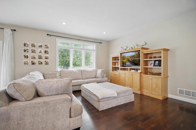 living area with dark wood-style floors and recessed lighting