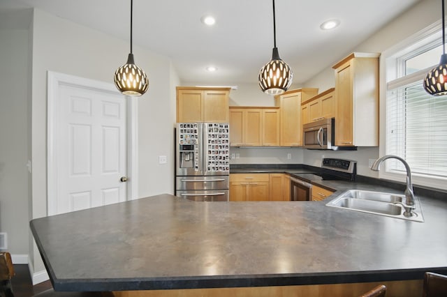 kitchen with appliances with stainless steel finishes, dark countertops, light brown cabinets, a chandelier, and recessed lighting