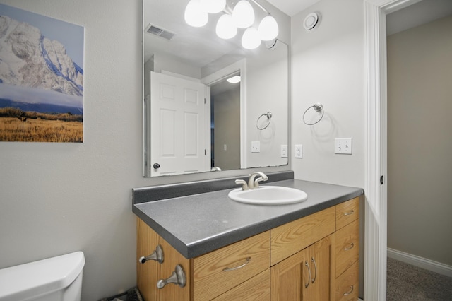 bathroom featuring toilet and vanity