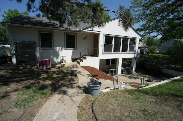 2417 S Ave E, North Saint Paul, MN 55109 - view of front of house featuring stucco siding and a shingled roof