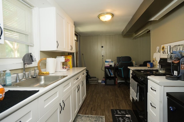 2417 S Ave E, North Saint Paul, MN 55109 - kitchen featuring black gas range oven, a sink, white cabinets, dark wood finished floors, and light countertops