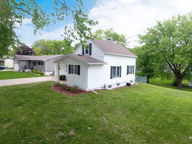 view of property exterior featuring roof with shingles, board and batten siding, and a garage