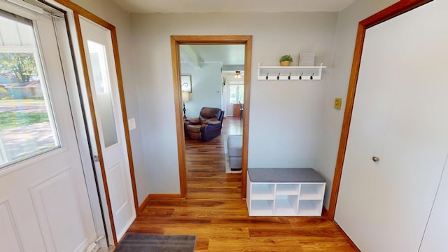 hallway featuring wood finished floors and baseboards