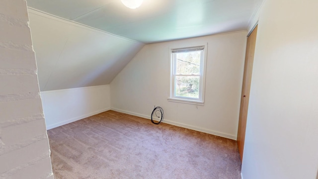 bonus room with baseboards, vaulted ceiling, and carpet floors