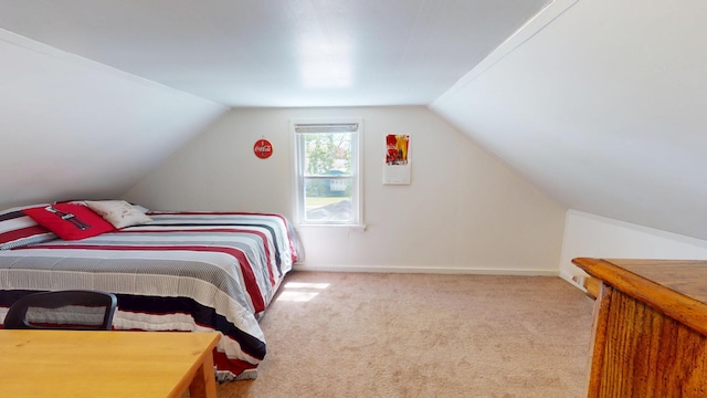 bedroom with carpet, vaulted ceiling, and baseboards