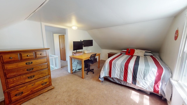 bedroom with vaulted ceiling and light carpet