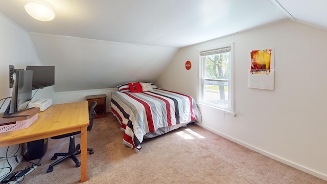 bedroom with lofted ceiling, carpet floors, and baseboards