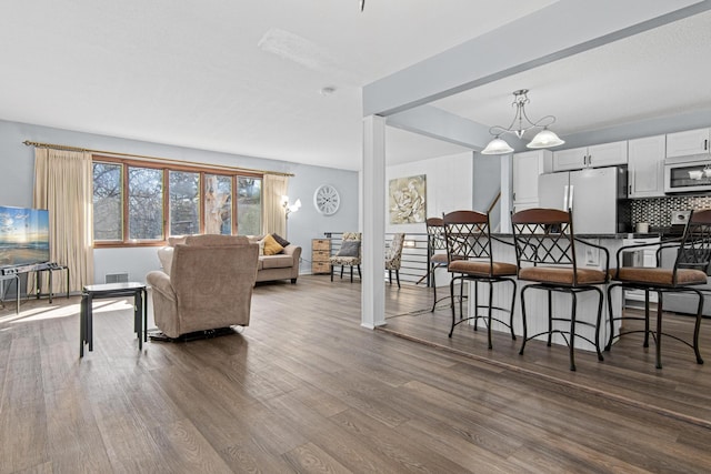12420 Chippewa Ln, Burnsville, MN 55337 - dining area with dark wood-style floors and a chandelier