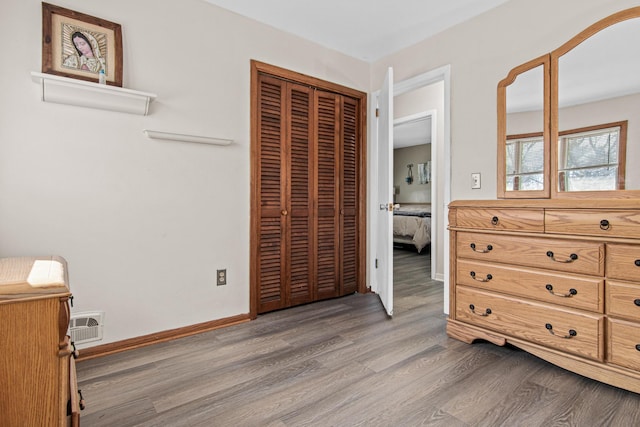 12420 Chippewa Ln, Burnsville, MN 55337 - bedroom with wood finished floors, a closet, and baseboards