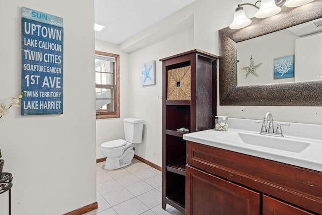 12420 Chippewa Ln, Burnsville, MN 55337 - bathroom featuring baseboards, tile patterned floors, toilet, and vanity