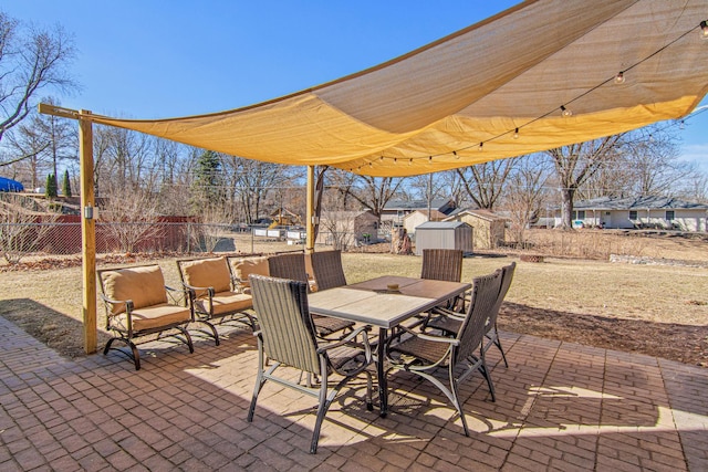 12420 Chippewa Ln, Burnsville, MN 55337 - view of patio / terrace featuring a shed, outdoor dining area, a fenced backyard, and an outbuilding