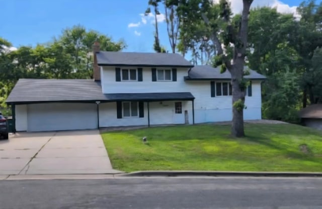 12420 Chippewa Ln, Burnsville, MN 55337 - tri-level home featuring driveway, a front lawn, a chimney, and an attached garage