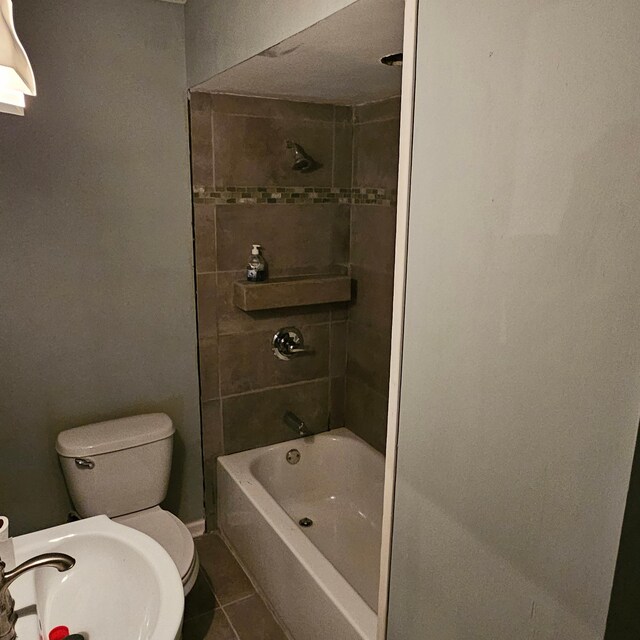 2407 4th St, Minneapolis, MN 55411 - bathroom featuring tile patterned floors, toilet, bathing tub / shower combination, and a sink