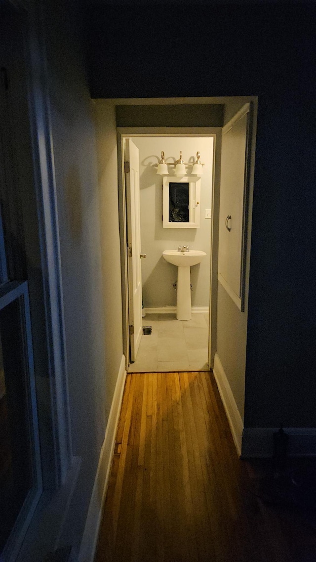 2407 4th St, Minneapolis, MN 55411 - corridor with wood-type flooring, baseboards, and a sink