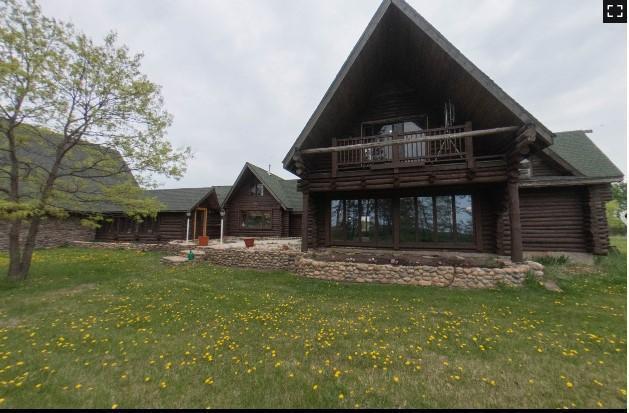 rear view of property with a yard and log exterior