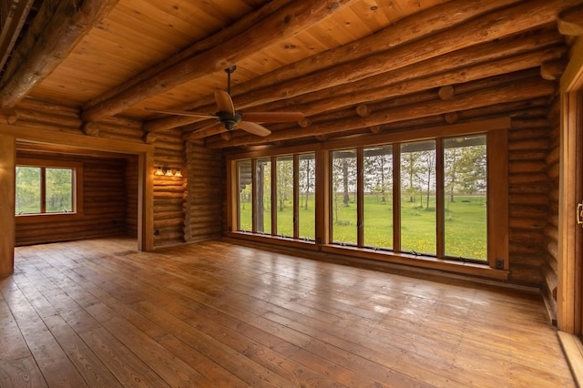 spare room featuring beamed ceiling, wooden ceiling, a ceiling fan, and hardwood / wood-style floors