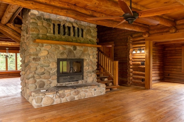 unfurnished living room featuring wooden ceiling, rustic walls, beam ceiling, hardwood / wood-style floors, and ceiling fan