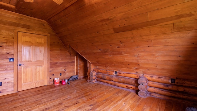bonus room with wood ceiling, lofted ceiling, wooden walls, and wood-type flooring