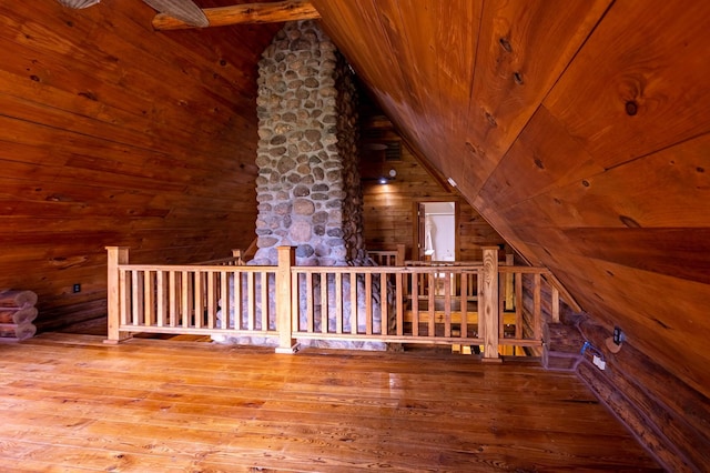 additional living space featuring lofted ceiling, wood walls, hardwood / wood-style flooring, and wood ceiling