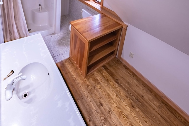 bathroom featuring a sink, tile patterned floors, and a shower